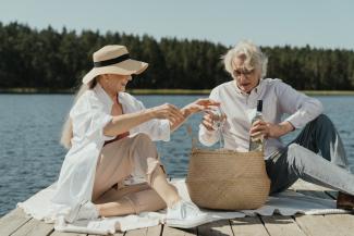 Two people having a picnic by a lake